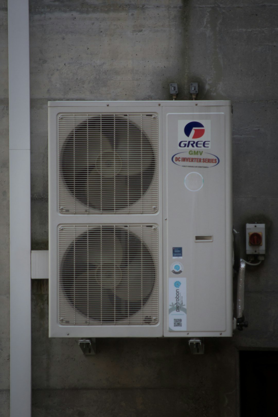 an-air-conditioning-unit-is-mounted-on-a-wall-vdtiwqwth78